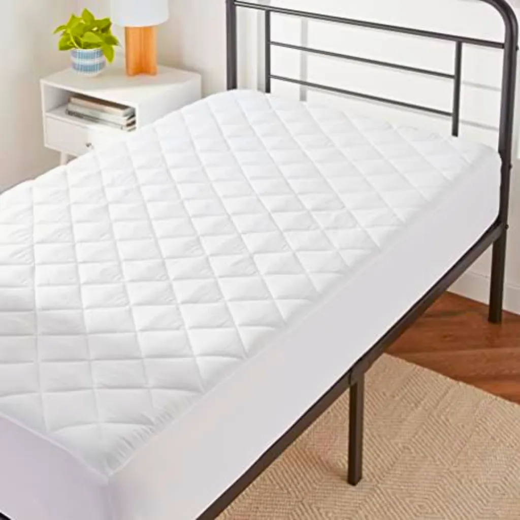 Quilted cooling mattress pad topper fitting deeply over a mattress edge